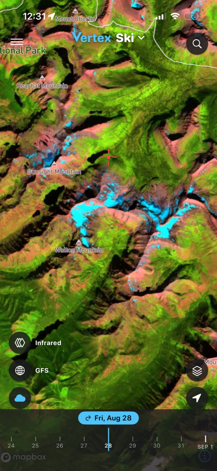 False-color infrared satellite scene from late August showing remaining snow in blue on the peaks